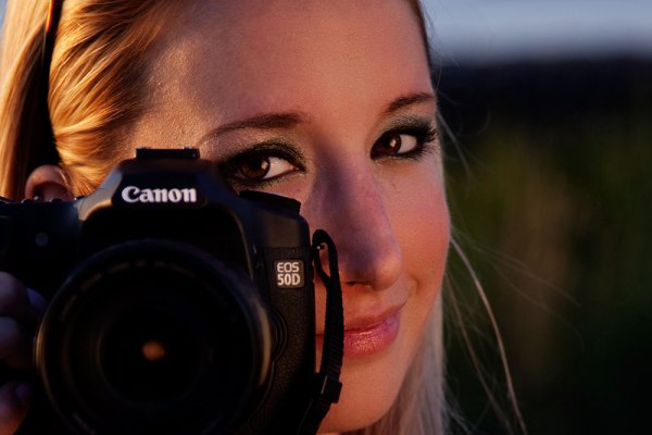 Here's my subject from the shot in front of the bridge. She's a photographer as well now, but back then she was just a hobbyist who wanted to know more about her camera. I used the beautiful sunset light I was getting, and set up a reflector to camera right to bounce the light back into her face. I wanted her peeking out from behind her camera, illustrating that she's into photography. EOS 5D Mark II with EF 24-105 f/4L IS. 1/250 @ f/4, ISO 100.